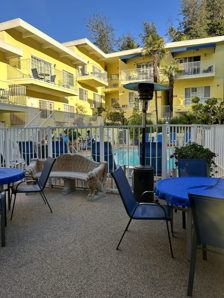 Tables to sit at outside pool area at the Magic Castle Hotel